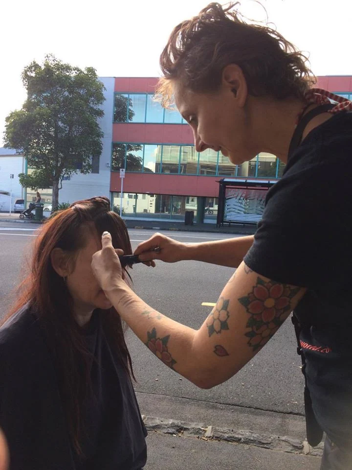 Margita styling a client’s hair outdoors