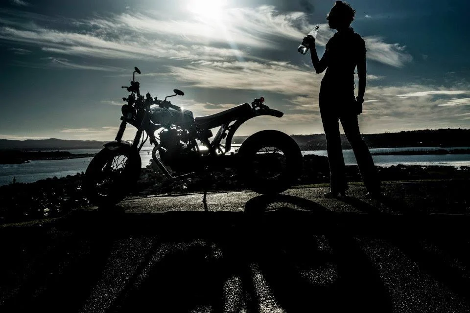 Margita and her motorcycle in silhouette