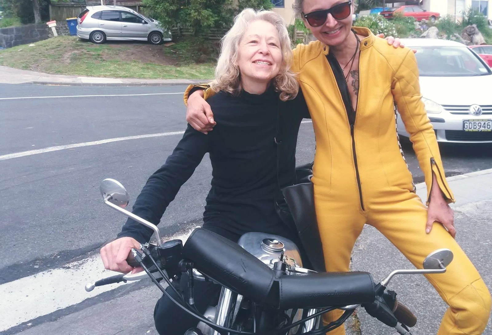 Friends beside a motorcycle